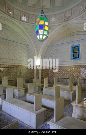 TUNIS, TUNISIA - JANUARY 01, 2020: The colorful interior of Tourbet el Bey Mausoleum, with tombs and stucco vaults Stock Photo