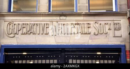A stone sign for the Co-operative Wholesale Society Ltd at their original offices in Manchester, uk Stock Photo