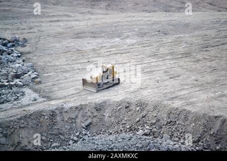 Tractor on the site of a granite quarry. view from aboveiew from above Stock Photo