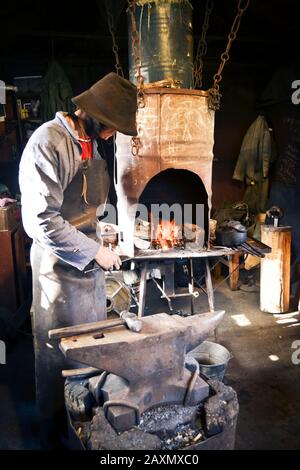 Man blacksmith in the smithy with filter Stock Photo