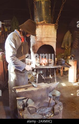 Man blacksmith in the smithy with filter Stock Photo