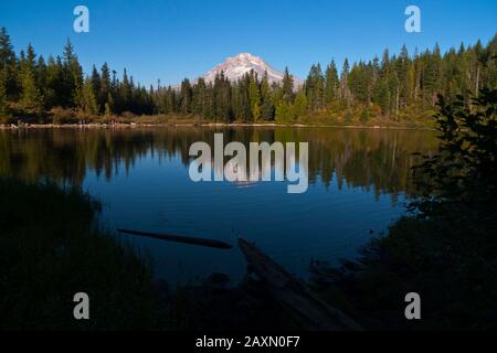 Mount Hood is reflected in a small alpine lake called Mirror Lake near Government Camp in Mt. Hood National Forest in Oregon, USA. Stock Photo