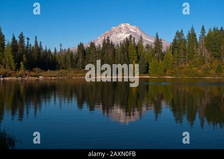 Mount Hood is reflected in a small alpine lake called Mirror Lake near Government Camp in Mt. Hood National Forest in Oregon, USA. Stock Photo