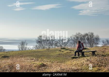 View of Morecambe Bay from bench in Arnside Park near Far Arnside, Cumbria. Stock Photo