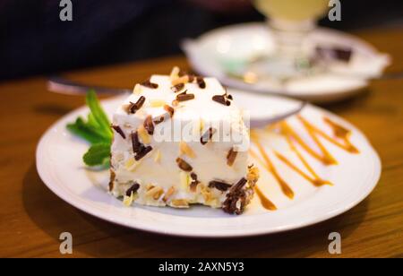a plate with tasty white cake on the table Stock Photo