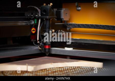 Computer cnc machine and wooden board in workshop, close-up Stock Photo