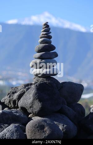 Stacked stone pyramid in front of the teide volcano, tenerife, spain Stock Photo