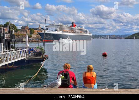 Fortress Akershus with transatlantic liner Queen Mary 2 in the harbour in the Oslo fjord, Oslo, Norway Stock Photo