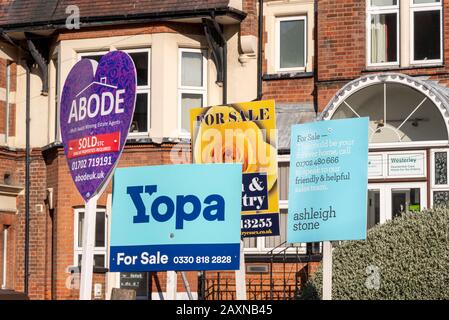 Yopa property for sale sign, among Abode, Town & Country and Ashleigh Stone signs. Online estate agent competing with traditional businesses Stock Photo