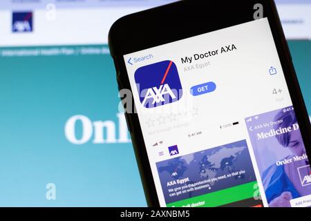 Los Angeles, California, USA - 12 February 2020: Mobile phone with My Doctor AXA icon on screen close up with website on laptop. Blurred background Stock Photo