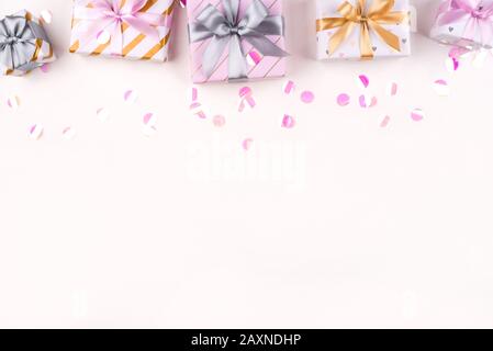 Set of gift boxes with bows and confetti on a white background. Stock Photo