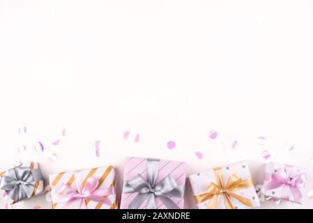 Set of gift boxes with bows and confetti on a white background. Stock Photo