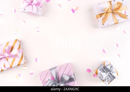 Several gift boxes with bows and confetti on a white background. Stock Photo