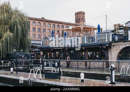 London, UK - November 26, 2019: People walking inside Camden Market, London. Started with 16 stalls in March 1974, Camden Market is one of the busiest