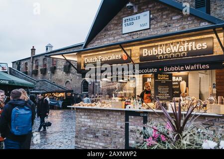 London, UK - November 26, 2019: Bubble waffles stall inside Camden Market, London. Started with 16 stalls in 1974, Camden Market is one of the busiest Stock Photo