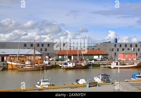 Boats moored along the quayside of the Nidelva River in Trondheim, Norway. P-Hotels Brattora is in the background. Stock Photo