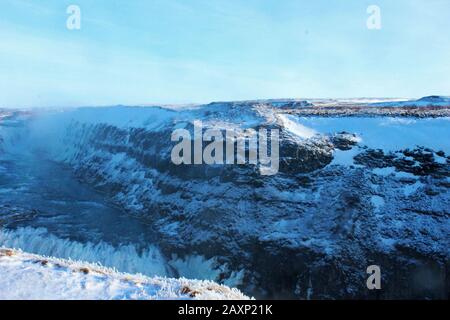Stunning scenery of rocks by the Gullfoss waterfall, Iceland on a bright day Stock Photo