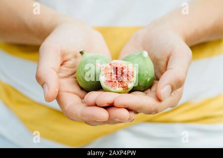 Figs in the hands of a young woman Stock Photo