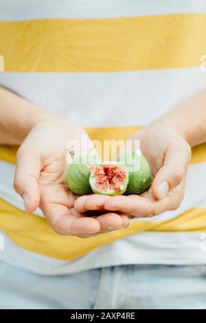 Figs in the hands of a young woman Stock Photo