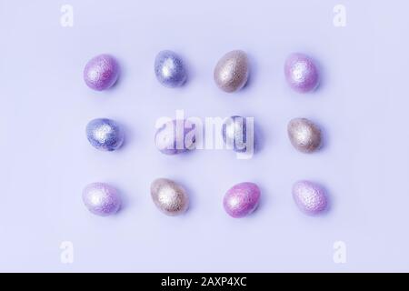 Colored chicken and quail eggs of pink, silver, golden and blue color  Stock Photo