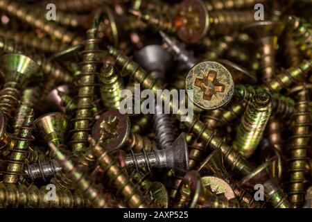 Gold and silver colored screws Stock Photo