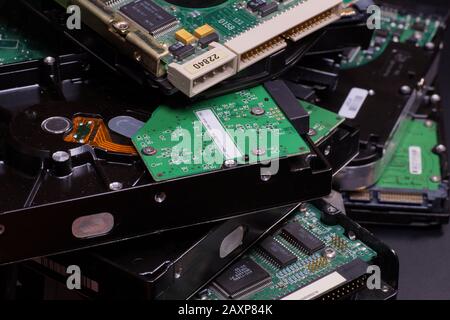 A stack of used hard drives. Worn electronics. Stock Photo