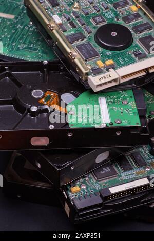 A stack of used hard drives. Worn electronics. Stock Photo