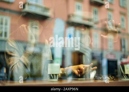 Happy young couple having fun wearing virtual reality glasses in cafe bar with glass reflection - Young people vr using new technology drinking take a Stock Photo