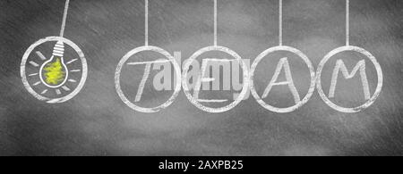 Team has sparking idea, drawn on slate blackboard Stock Photo
