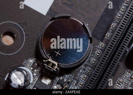 Lithium Battery Coin On Computer Motherboard Stock Photo