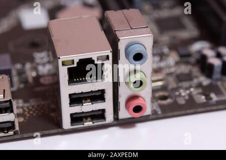 Lan socket RJ 45 and Audio output socket on computer motherboard isolated on white background Stock Photo