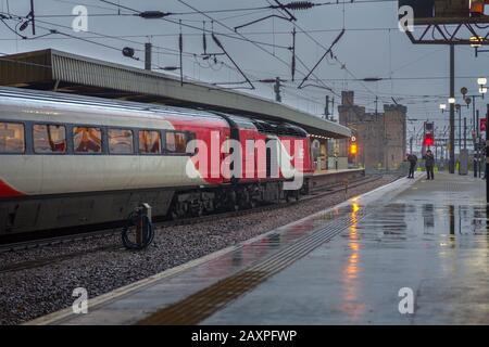 London North eastern railway ( LNER ) high speed train  (Intercity 125 ) at Newcastle central station with rail enthusiasts taking  a photograph of it Stock Photo