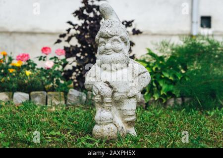 Small dwarf statue in backyard Stock Photo