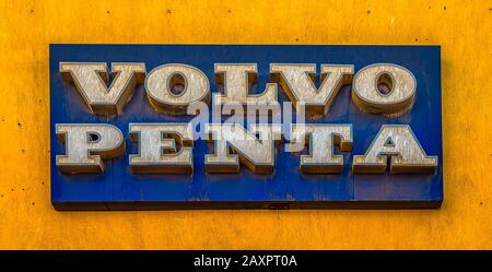 volvo penta, a blue rectangular sign with white letters on a yelloow wall, El Gouna, Egypt, January 16, 2020 Stock Photo