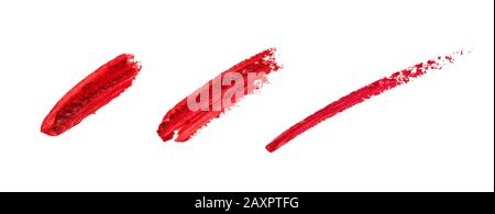 Smudged lipstick strokes for decoration design. Smear hand drawing lines. Red color cosmetic product brush stroke sample. Textured Paint line isolated on white background. Stock Photo