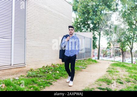 Young bearded man walking around in the city Stock Photo