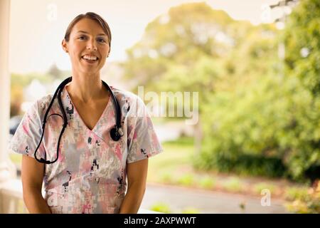 Female nurse with a stethoscope around her neck  poses for a portrait. Stock Photo