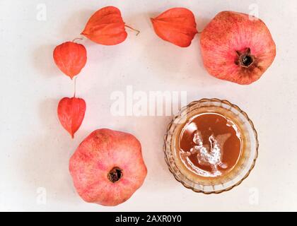 Orange organic lotion (toner) or juice, Physalis and pomegranate Stock Photo