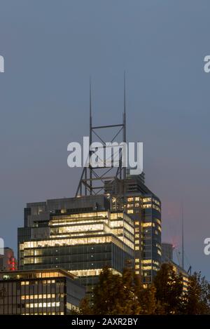 The Deutsche Bank tower aerials pierce the low clouds on a rainy Sydney night in Australia Stock Photo