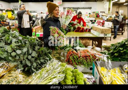 Chicago, USA. 12th Feb, 2020. A customer selects flowers at a floral wholesale market in Chicago, the United States, on Feb. 12, 2020. With Valentine's Day being one of their busiest weeks of the year, employees of floral wholesale markets in Chicago work hard to meet the demand of customers. Credit: Joel Lerner/Xinhua/Alamy Live News Stock Photo