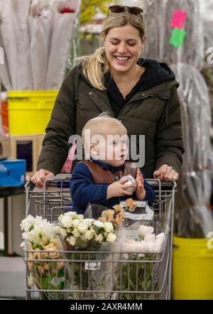 Chicago, USA. 12th Feb, 2020. A customer shops flowers with her kid at a floral wholesale market in Chicago, the United States, on Feb. 12, 2020. With Valentine's Day being one of their busiest weeks of the year, employees of floral wholesale markets in Chicago work hard to meet the demand of customers. Credit: Joel Lerner/Xinhua/Alamy Live News Stock Photo