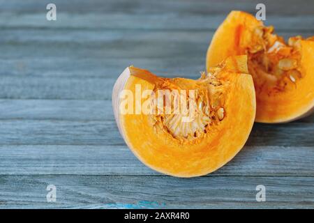Two bright orange pumpkin slices on gray background Stock Photo