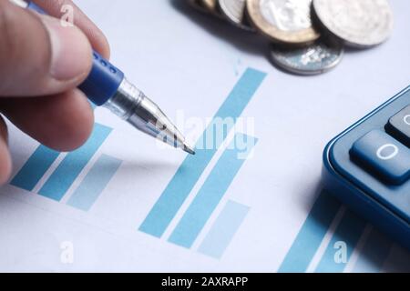 Close up of man hand analyzing chart on paper  Stock Photo
