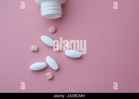 Top view of pill spilling out from container  Stock Photo