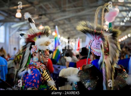 San Francisco, USA - February 08, 2020: Native American Indians wearing intricate porcupine roaches and traditional outfits dancing at a powwow Stock Photo