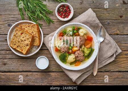 meatballs soup in white plate on old wooden rustic grey table, top view Stock Photo
