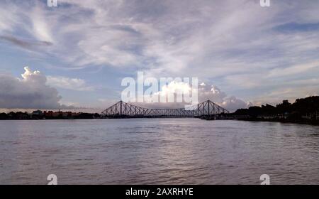 Howrah bridge - The historic cantilever bridge on the river Hooghly with twilight sky. Howrah bridge is considered as the busiest bridge in India. Stock Photo