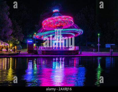 Summer festival in the Olympic Park with Olympic lake at night Munich, Bavaria, Germany, Europe Stock Photo