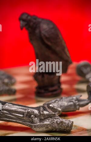 Сhess as an abstract concept. Beautiful antique chess set on marble chess board. Stock Photo