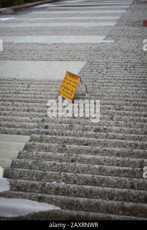 Asbestos corrugated roof with yellow sign, Warning Brittle roof covering use planks or ladders - In Emergency Only Stand or walk on lines of nails Stock Photo